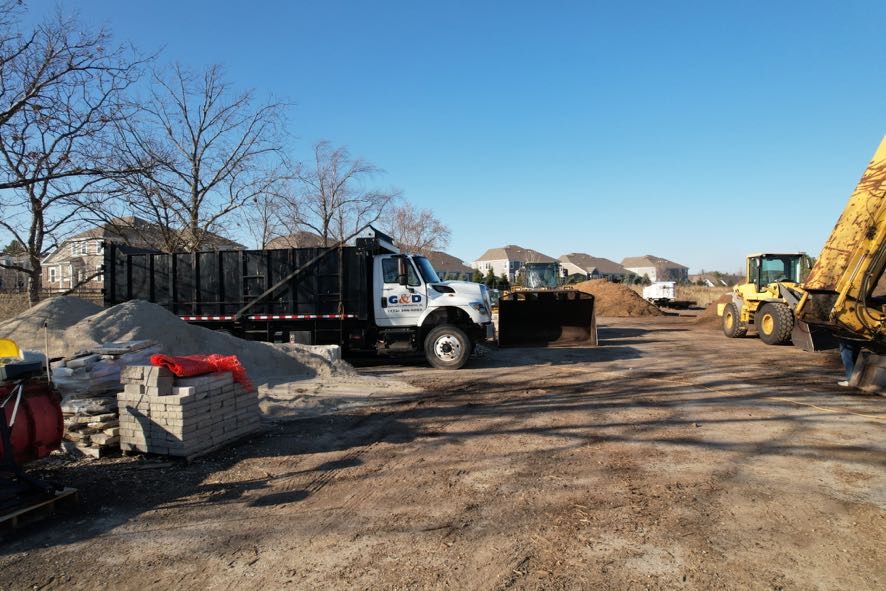 G&D branded truck with equipment at mulch yard