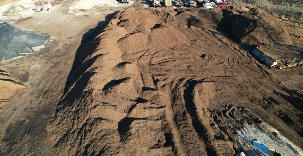Drone view of massive bulk mulch stockpiles at G&D Materials